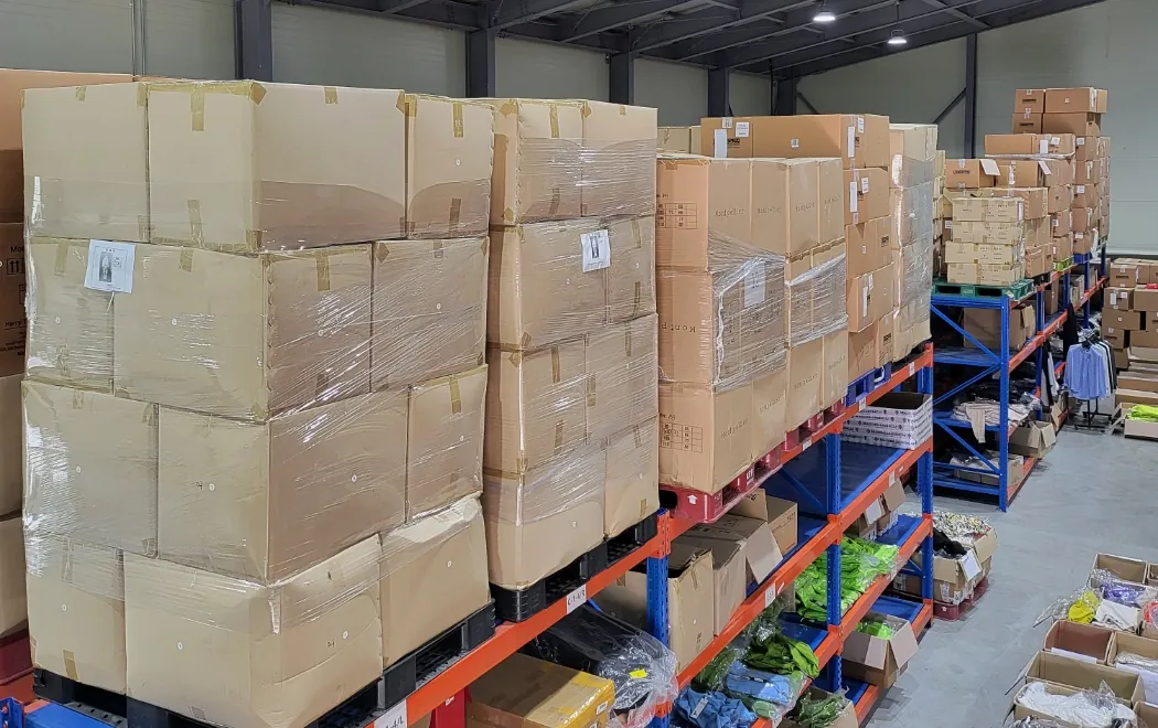 Palletized cartons and racked apparel inside the Korea warehouse