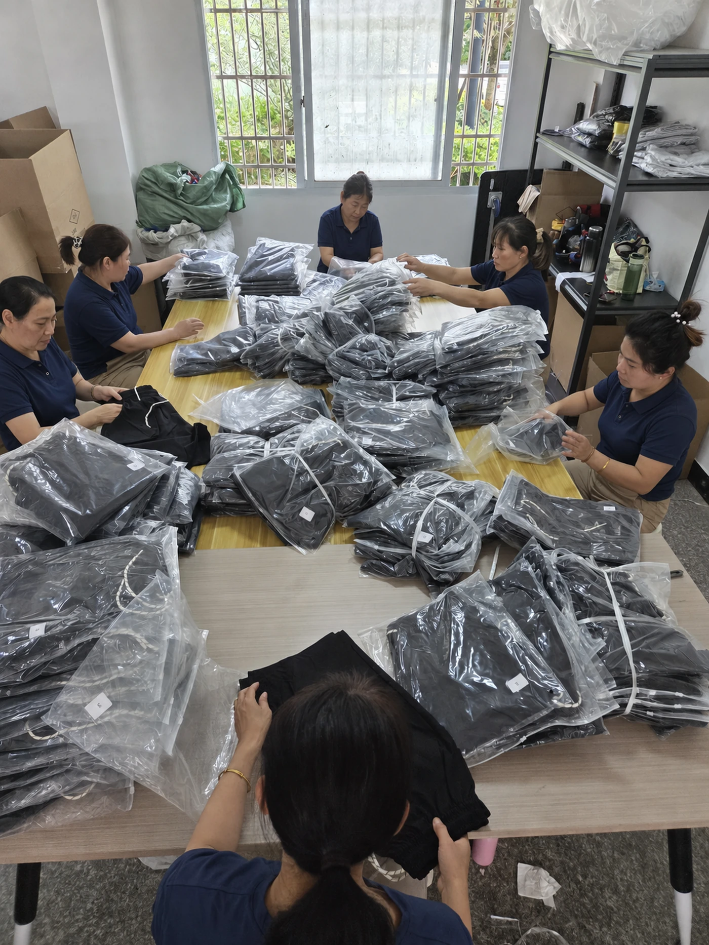 Workers checking and processing finished units on the production floor